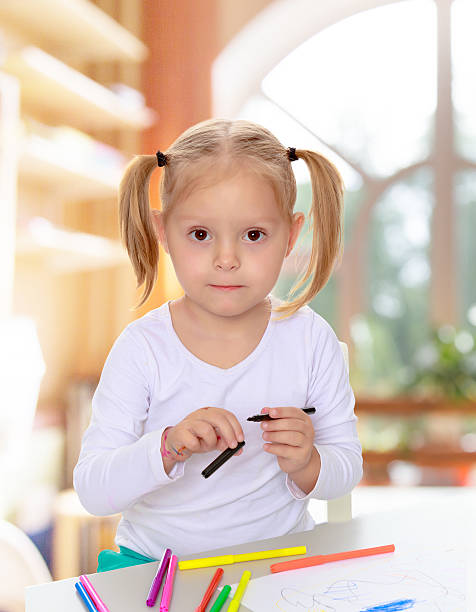 istock The girl draws with markers 600136254