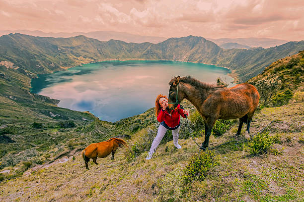 istock Young Woman Hiking With Two Horses 600139440