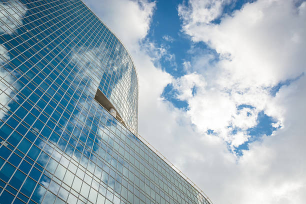 istock Modern glass hi-rise building skyscraper over blue bright sky 600139512