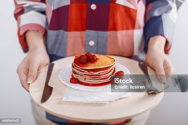 Woman Holds Cutting Board With Plate American Pancakes With Raspberry Stock Photo - Download Image Now