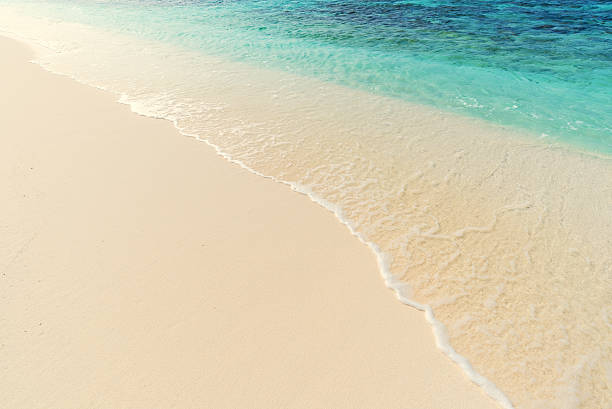 istock Sea waves and beach sand background 600142028