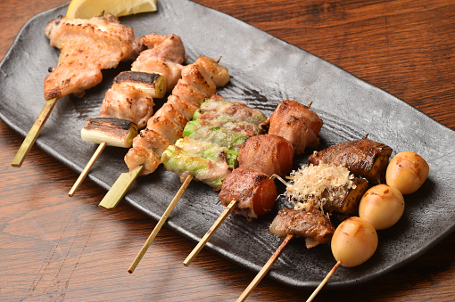 Yakitori is a Japanese specialty where various parts of the chicken are skewered and charbroiled by the chef. They are usually served simply with only salt or dipped into teriyaki like sauces.