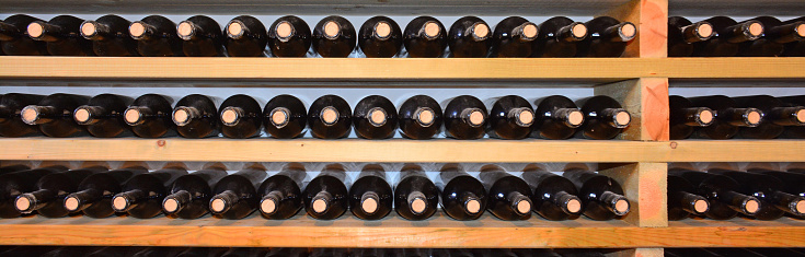 Wine cellar -  with bottles on wooden shelves