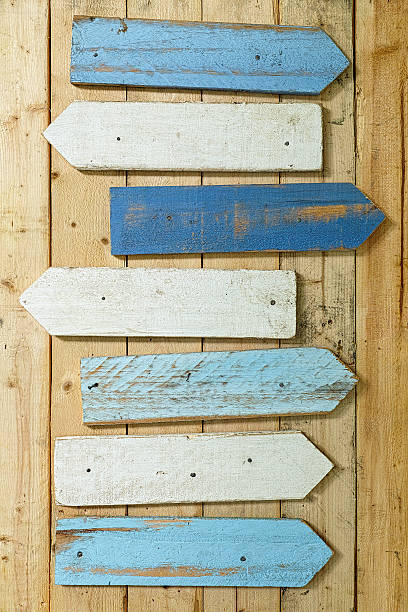 istock Old  weathered blue and white wood arrow signs. 600147530