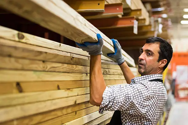 mature man Working at a timber/lumber warehouse