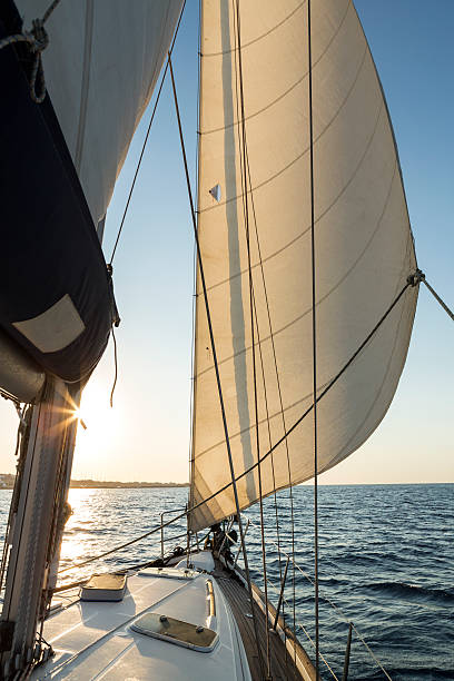 istock Sunrise sailing at sea on a sailboat 600149198