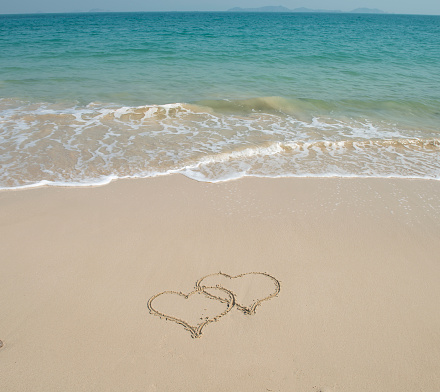 two hearts in sand on a beautiful beach