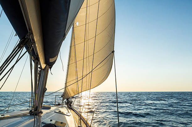 istock Sailboat sailing at sea with sunrise 600149426