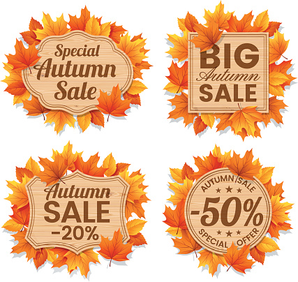 Autumn leaf sale tags and text Autumn Sales on wood background.