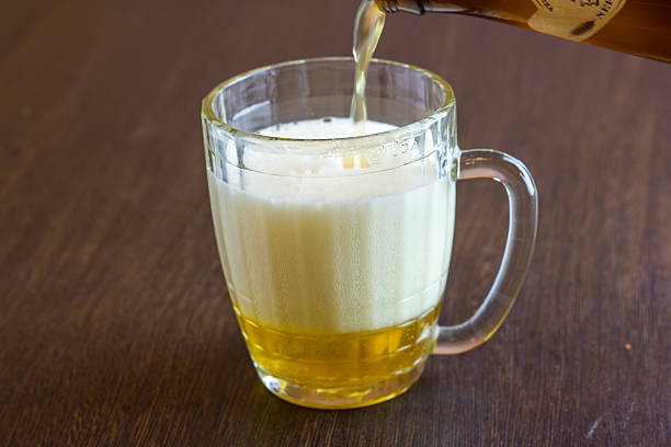 istock pouring beer from bottle into mug at bar 600152578