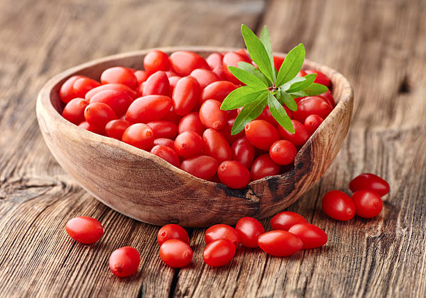 Goji berries on a wooden board stock photo