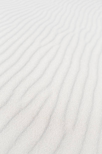 istock waves of white sand formed by wind 600153348