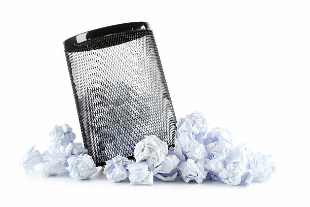 istock Office trashcan with crumpled paper balls isolated on white 600154682
