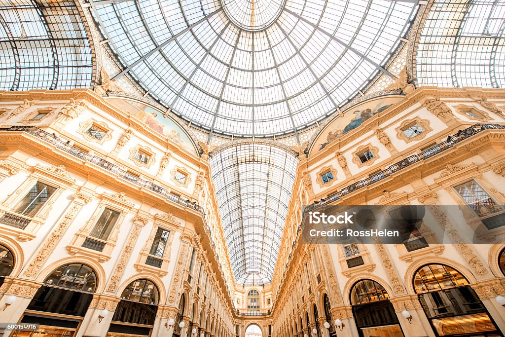 Old shopping galler Interior with beautiful glass vaults in the famous Vittorio Emanuele shopping gallery in the center of Milan city. Art Museum Stock Photo