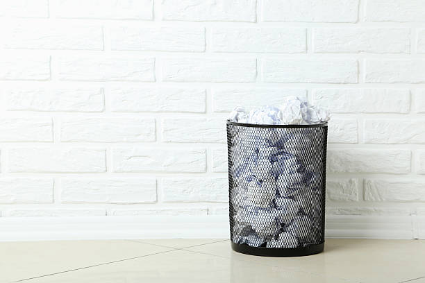 istock Office trashcan with crumpled paper balls 600155168