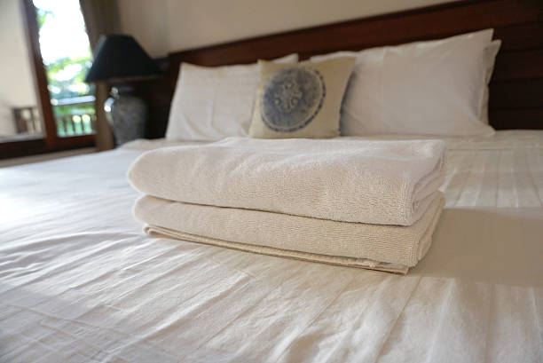 istock White towels on white bedsheet 600156620