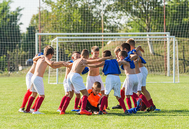 istock kids soccer team in huddle 600157156