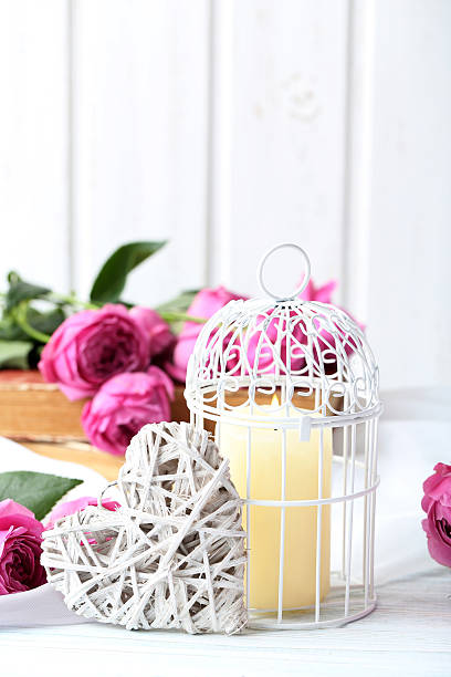 istock Beautiful pink roses on a white wooden table 600158228