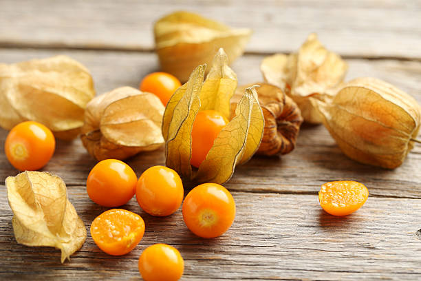 Ripe physalis on a grey wooden table stock photo