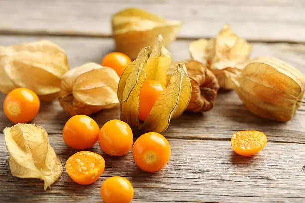 Ripe physalis on a grey wooden table