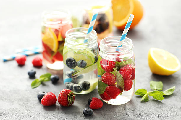 istock Detox water in bottles with berries on wooden table 600160138