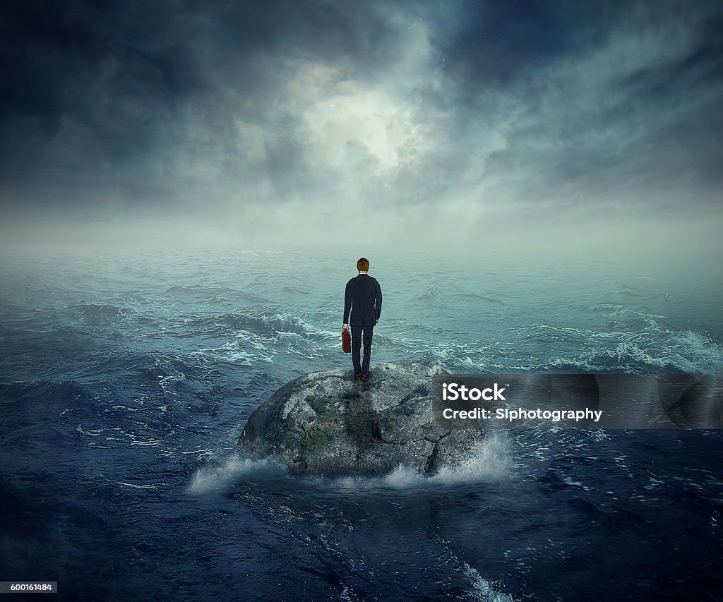 Failure crisis concept lost business career education opportunity Failure crisis concept and lost business career education opportunity. Lonely young man on a rock cliff island surrounded by an ocean storm waves Storm Stock Photo