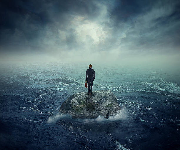Failure crisis concept lost business career education opportunity Failure crisis concept and lost business career education opportunity. Lonely young man on a rock cliff island surrounded by an ocean storm waves survival stock pictures, royalty-free photos & images