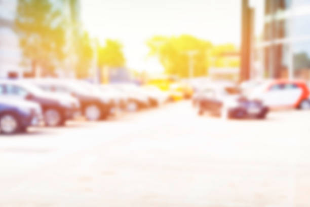 Abstract background of blurred  cars in front of dealership place, blurred background