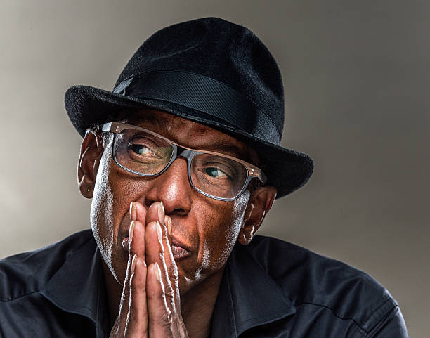 istock Serious Man with pensive  look, hands clasped, looking away 600162468