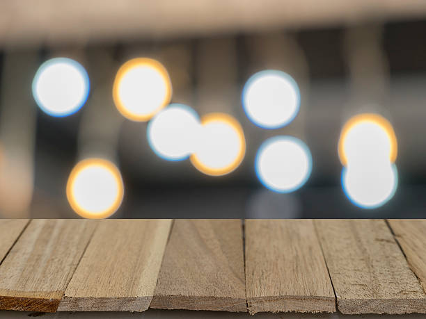 istock wood table top on blur background of bokeh light 600164180