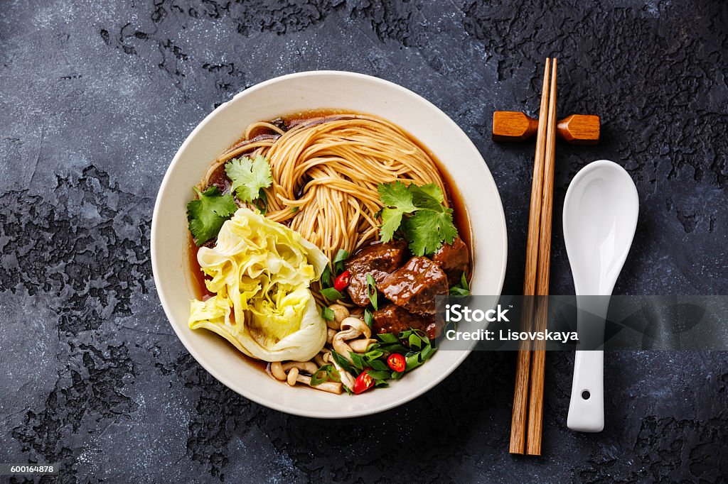 Noodles in broth with Beef Spicy asian noodles in broth with Beef on dark background Beef Stock Photo