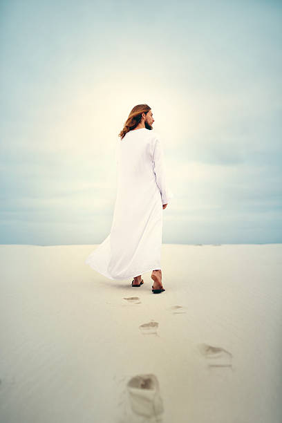 Footprints in the sand Shot of Jesus walking in a sandy landscape ceremonial robe stock pictures, royalty-free photos & images