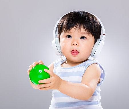 Chinese toddler with headphones and balls