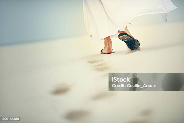 It Is In Difficult Times That He Carries You Stock Photo - Download Image Now - Jesus Christ, Walking, Christianity