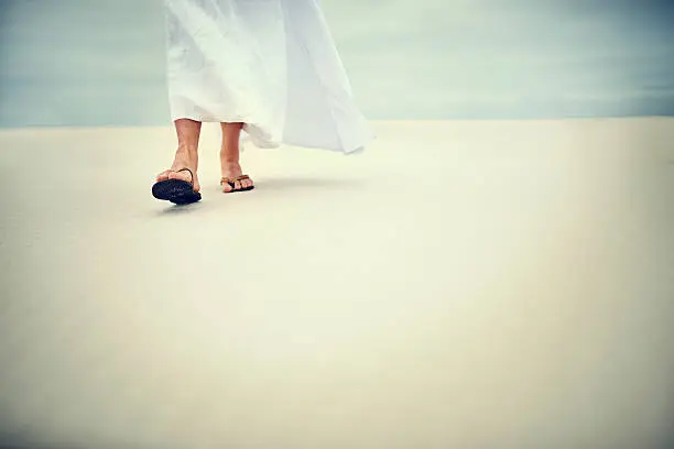 Shot of Jesus walking in a sandy landscape
