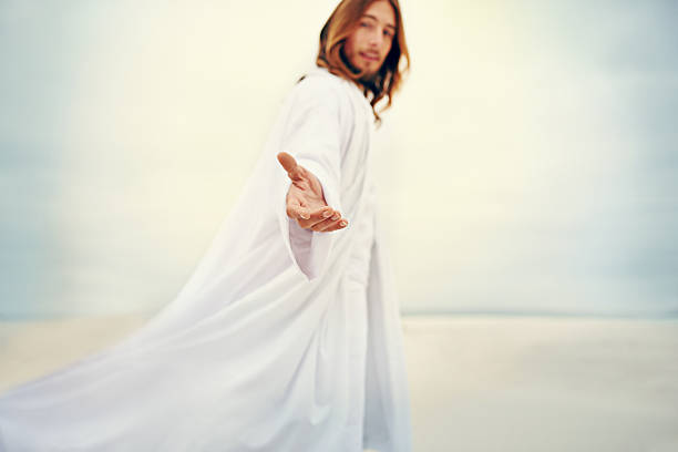 For my yoke is easy and my burden is light Shot of Jesus standing with his hand outstretched on a bare landscape jesus christ photos stock pictures, royalty-free photos & images