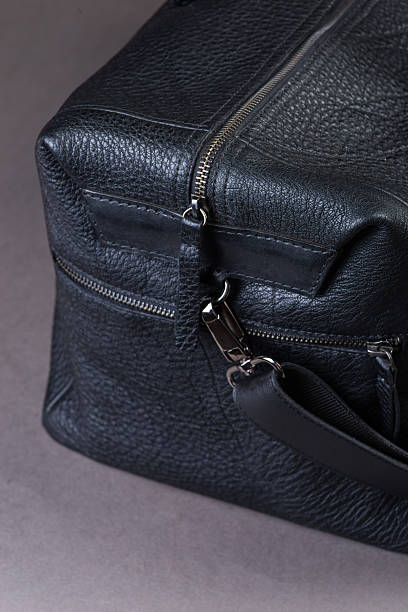 istock Black leather traveling bag, over the concrete wall background 600167366