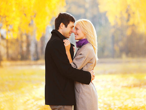 istock romantic smiling couple in love sunny day over yellow leafs 600167620