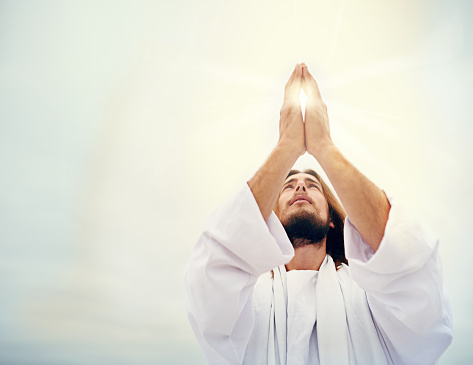 Shot of Jesus standing in a bare landscape