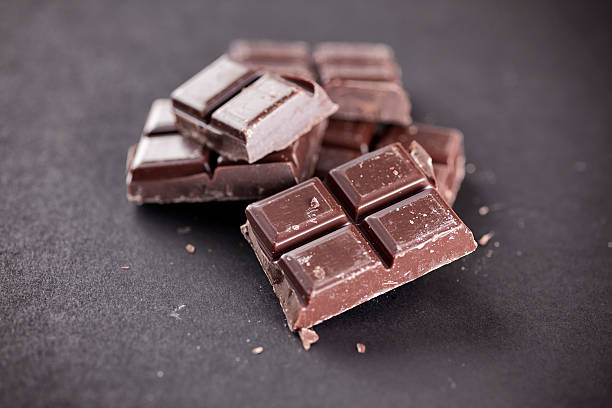 istock Pieces of chocolate on a black background 600168160