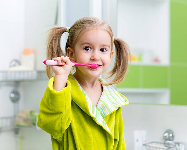 istock Little girl brushing teeth in bath 600170046