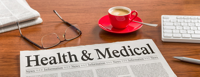 A newspaper on a wooden desk - Health and Medical