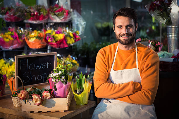 istock Male florist sitting near table 600170976