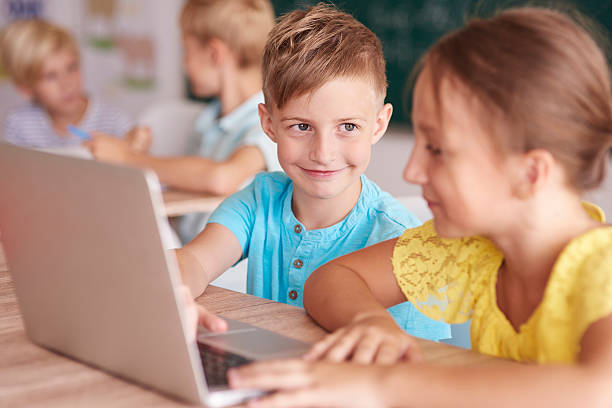 istock Girl and boy using the computer in the classroom 600172856
