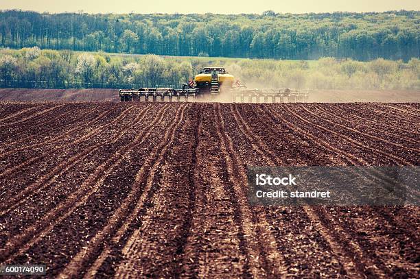 Tractor Plowing Farm Field In Preparation For Spring Planting Stock Photo - Download Image Now