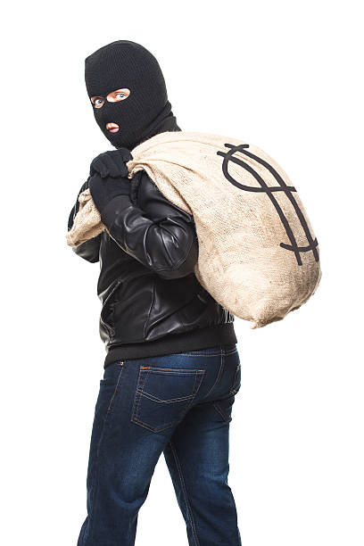 istock Thief   and full bag of money 600175686