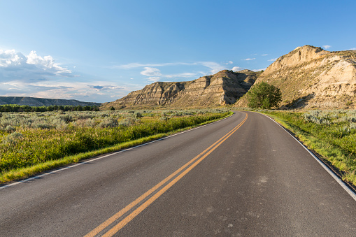 A road traveling through badlands.