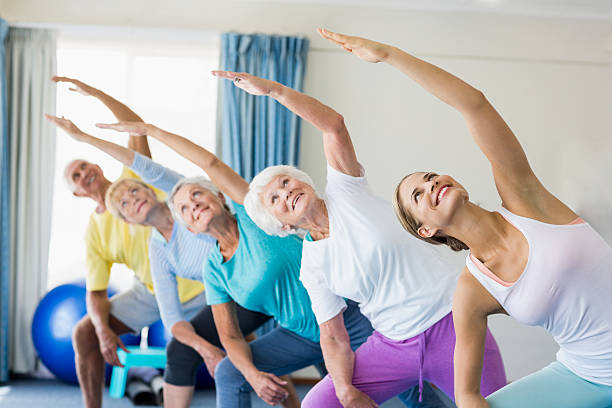istock Instructor performing yoga with seniors 600176994