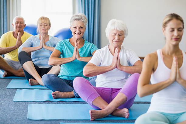 istock Instructor performing yoga with seniors 600177020