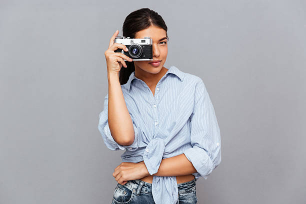 istock Cheerful woman making photo with camera 600177660
